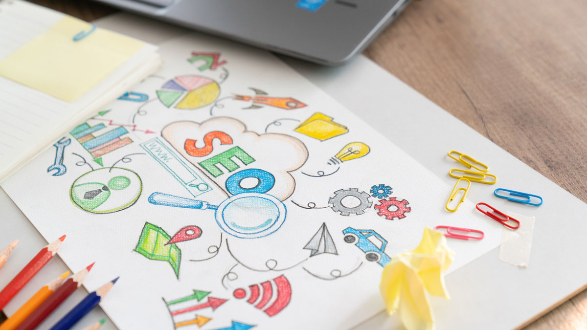 Content strategy sketches, keyword notes and a laptop on a desk